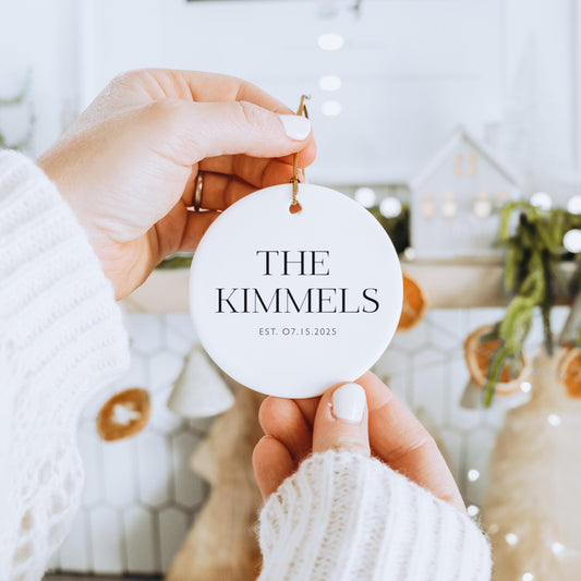 First Christmas Ornament Newlywed Gift Personalized Ceramic Design Custom Family Name Wedding Date Display Modern White Round Shape Gold String Detail Holiday Keepsake Collection Special Moment Celebration Beautiful Family Tradition Memory